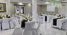 Load image into Gallery viewer, Decorated banquet hall with tables set for a Wedding Reception